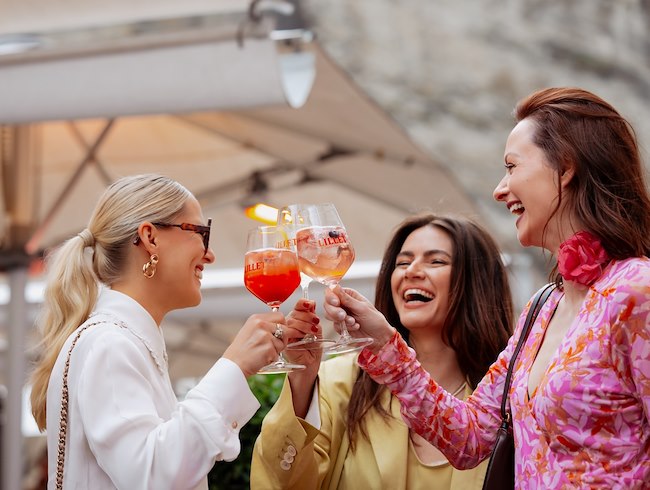 Group of ladies having a drink at the Summer Opening event